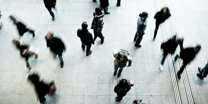 Photo : un ensemble de personne se croisant devant un immeuble d'entreprise